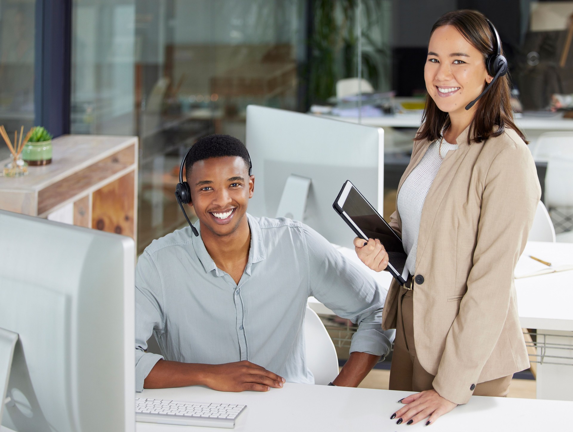 Shot of a young man and woman using a computer while working in a call centre